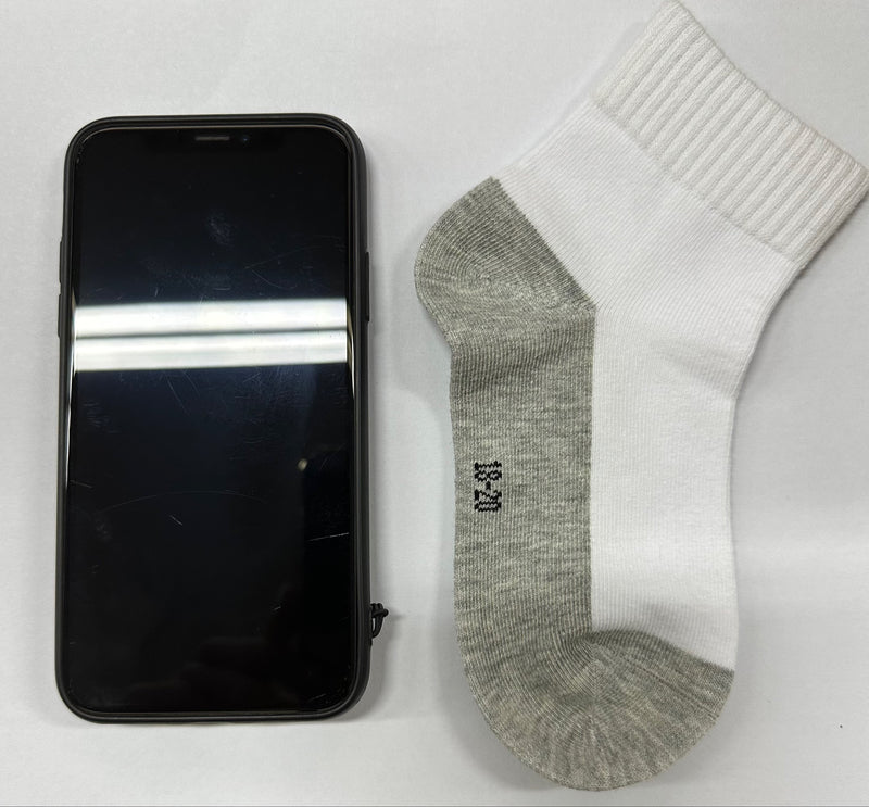 white socks with iphone X size comparison